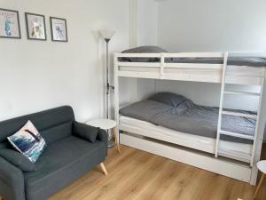 a living room with a couch and bunk beds at Möwennest in Nienhagen
