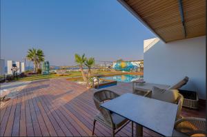 a patio with a table and chairs and a pool at VENTO MARE LUXURY Hotel in Cesme