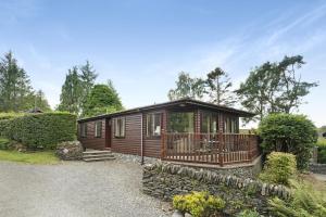 a log cabin with a porch and a balcony at Lilac Lodge at Pound Farm in Crook