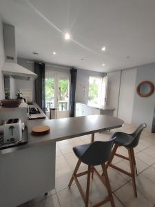a kitchen with a table and two chairs in it at Gite Les Brugues - Lisle sur Tarn in Lisle-sur-Tarn