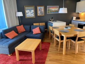 a living room with a blue couch and a table at Levi Chalets 1508 Visit Levi in Levi