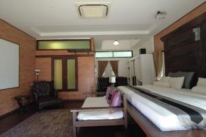 a bedroom with a large bed and a chair at Villa D'Acqua in Masjid Tanah +36 photos