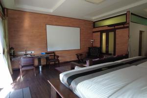 a bedroom with a large bed and a blank screen at Villa D'Acqua in Masjid Tanah