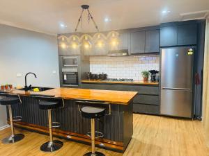 a kitchen with a counter and a refrigerator at Villa Twelve in Sigatoka