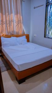 Ένα ή περισσότερα κρεβάτια σε δωμάτιο στο Hotel Rolax - Dodoma
