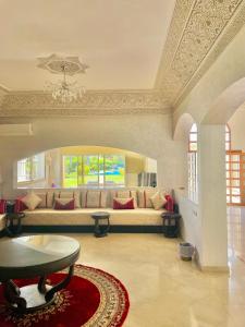 a living room with a couch and a table at villa dar esalam in Rabat