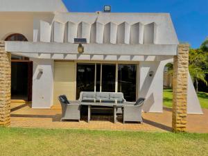a patio with a table and chairs in front of a house at villa dar esalam in Rabat