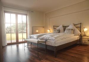 a bedroom with a large bed and a large window at Ferienhaus Am Riedl in Siegsdorf
