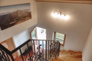 a staircase in a house with a painting on the wall at Ferienhaus Am Riedl in Siegsdorf +27 photos