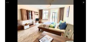 a living room with a couch and a window at FeWo Usedom Karlshagen in Karlshagen +10 photos