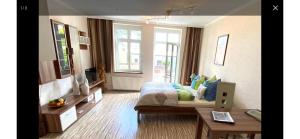 a bedroom with a bed and a desk and a window at FeWo Usedom Karlshagen in Karlshagen