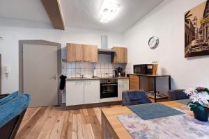 a kitchen and living room with a table and chairs at Casa Doro in Donaueschingen +10 photos
