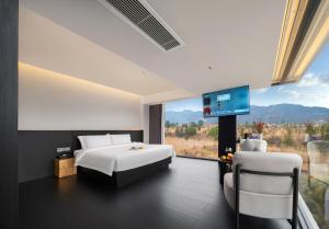 a bedroom with a bed and a flat screen tv at 1982 Holiday Homestay in Zhangjiajie
