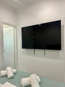 a living room with a flat screen tv on a wall at Hera Luxury Suite by Zeus Suites in Athens