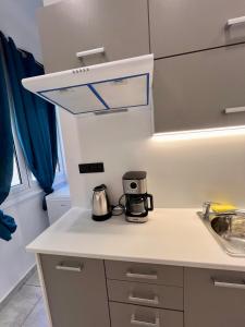 a kitchen with a counter top with a coffeemaker at Hera Luxury Suite by Zeus Suites in Athens