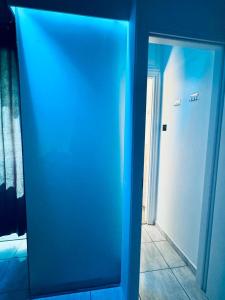 a blue mirror in a room with a door at Hera Luxury Suite by Zeus Suites in Athens