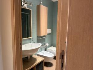 a bathroom with a sink and a toilet at EUREKA APArtment in Catania +36 photos