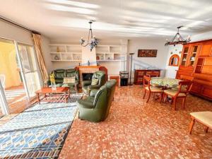 a living room filled with furniture and a fireplace at Villa Marietta, private pool villa with sea views and terrace, perfect for families and remote stays in Almuñécar