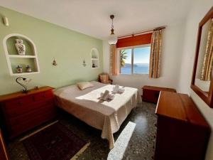 a bedroom with a bed and a window at Villa Marietta, private pool villa with sea views and terrace, perfect for families and remote stays in Almuñécar +64 photos