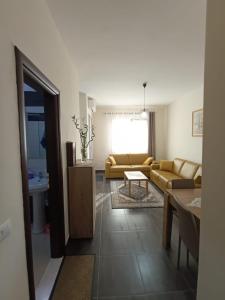 a living room with a couch and a table at Cozy apartment Lalez in Shetaj