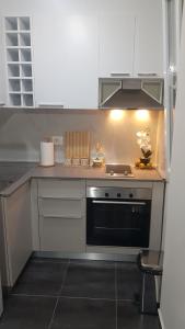 a small kitchen with a stove and a sink at Cozy apartment Lalez in Shetaj