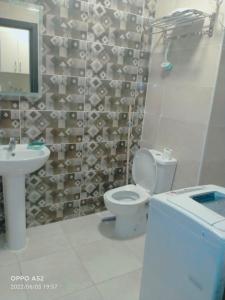 un baño con inodoro y lavabo en قرية أكوا فيو الساحل الشمالي - Aqua View El Alamein, en El Qasaba esh Sharqīya