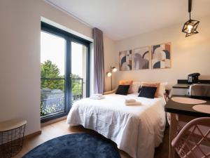 a bedroom with a bed and a large window at La Ferme d'Estelle in Vulmont