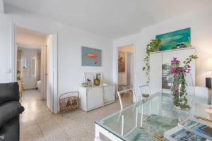 a living room with a glass table and a couch at Next to piletas 67 Sanlucar de Barrameda in Sanlúcar de Barrameda