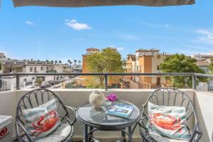 a table and chairs on a balcony with a view of a city at Next to piletas 67 Sanlucar de Barrameda in Sanlúcar de Barrameda