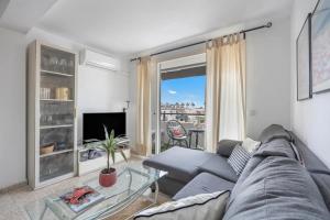 a living room with a couch and a glass table at Next to piletas 67 Sanlucar de Barrameda in Sanlúcar de Barrameda