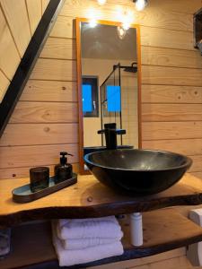 a bathroom with a black sink and a mirror at Macko’s cabin in Băile Tuşnad +37 photos