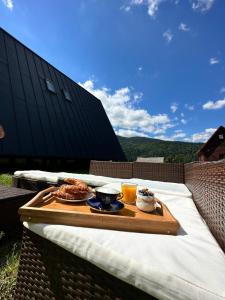 a table with a tray of food on a table at Macko’s cabin in Băile Tuşnad