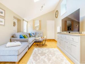 a living room with a couch and a table at Benchmark Cottage in Glaisdale +32 photos