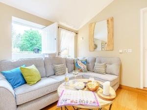 a living room with a couch and a table at Benchmark Cottage in Glaisdale
