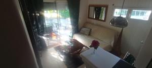 a living room with a couch and a table at Camélias in Laboutarié