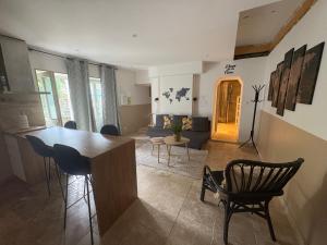 a living room with a table and chairs at Domus de la Pierre in Autun