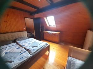 a bedroom with a bed in a wooden room at Owl's Nest Bovec in Bovec +4 photos
