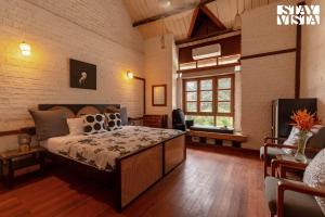 a bedroom with a large bed in a room at StayVista at Orchard by the River with Bonfire, BBQ in Karjat