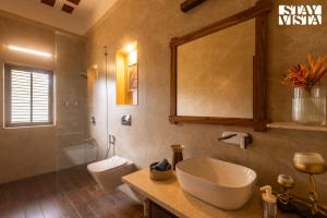 a bathroom with a sink and a toilet at StayVista at Orchard by the River with Bonfire, BBQ in Karjat +29 photos