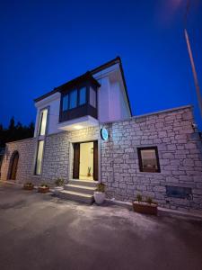 a white brick building with a large window at Kırçak Konak in Çeşme