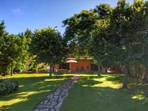 a garden with trees and a stone path at Belvilla by OYO Tosco in Valiano
