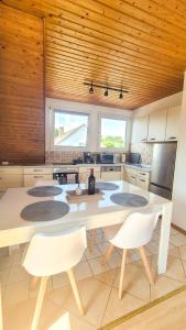 a kitchen with a large white table and white chairs at Cozy City Apartments 3, 2-Room Flat for Vacation & Messe Düsseldorf, Perfect Connectivity in Ratingen