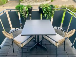 a white table and chairs on a balcony at Suite4you Erlen l Privater Indoorpool ganzjährig beheizt & Sauna l 10min zum Bodensee, Parkplatz & WLAN in Erlen +38 photos