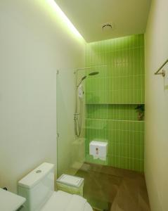 a green tiled bathroom with a toilet and a shower at Paradise House - 1BR - Calm & Green Garden Stay - Heart of Thong Sala - 4K SmartTV in Koh Phangan +47 photos