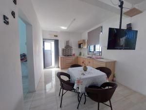 a kitchen and dining room with a table and chairs at Rose villa in Pereybere
