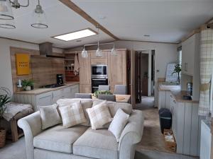 a living room with a couch and a kitchen at Fir Tree - 2 bedrooms sleeps 5 in Hastings