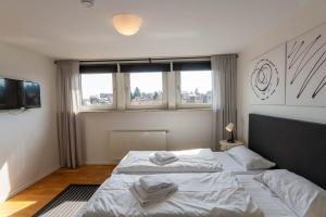 a bedroom with two beds and two windows at Ferienhaus Malte in Braunlage