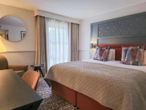 a hotel room with a bed and a mirror at Smiths At Gretna Green Hotel in Gretna Green