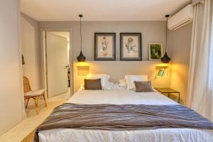 a bedroom with a large white bed with two pillows at House with private pool in Calella de Palafrugell +24 photos