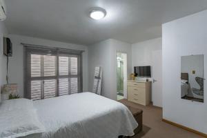 Ένα ή περισσότερα κρεβάτια σε δωμάτιο στο Casa grande e aconchegante
